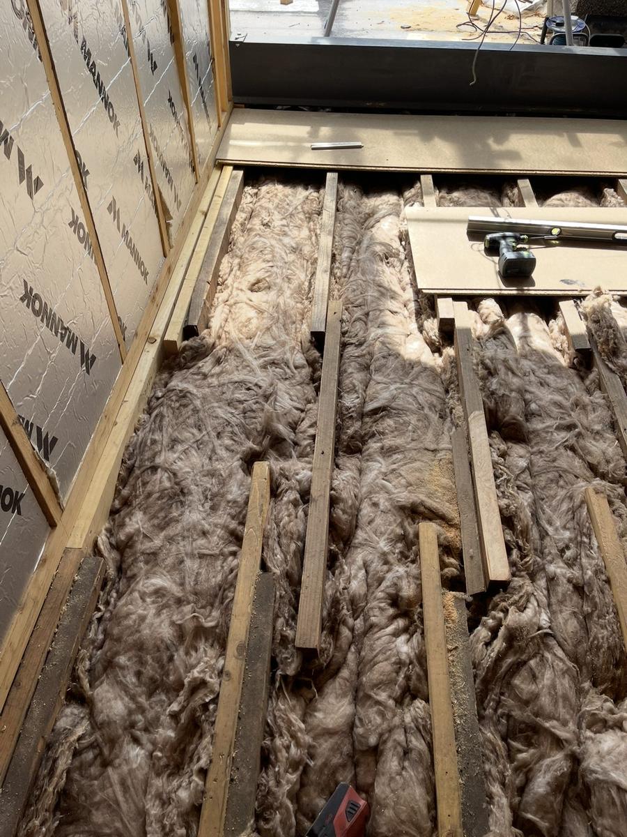 Mineral wool fitted between suspended floor joists, The Grange