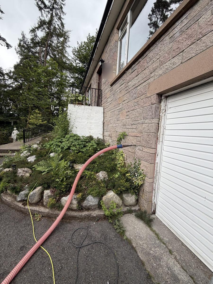 Cavity wall injection at low level beside an integral garage, Highlands