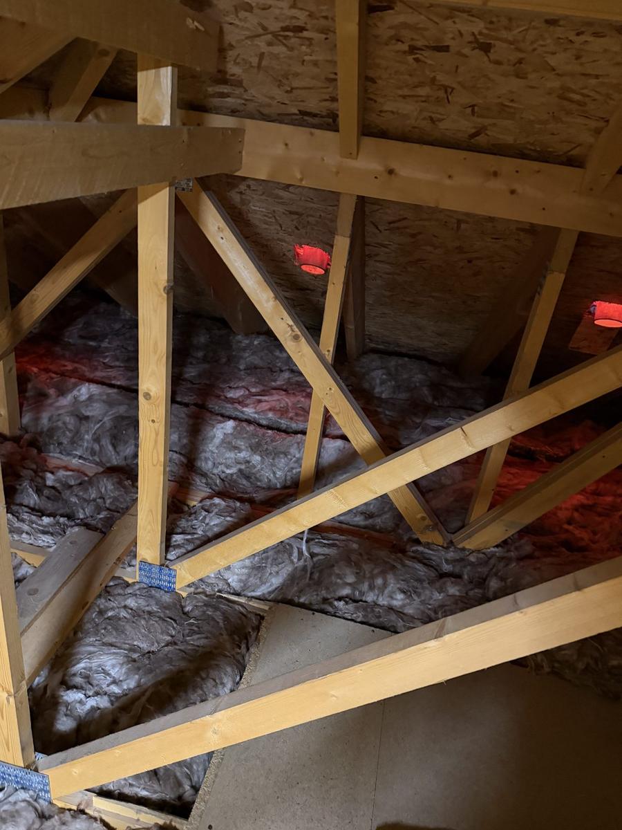 Red fire-rated covers fitted over recessed downlights before the second layer of loft insulation, Inverness