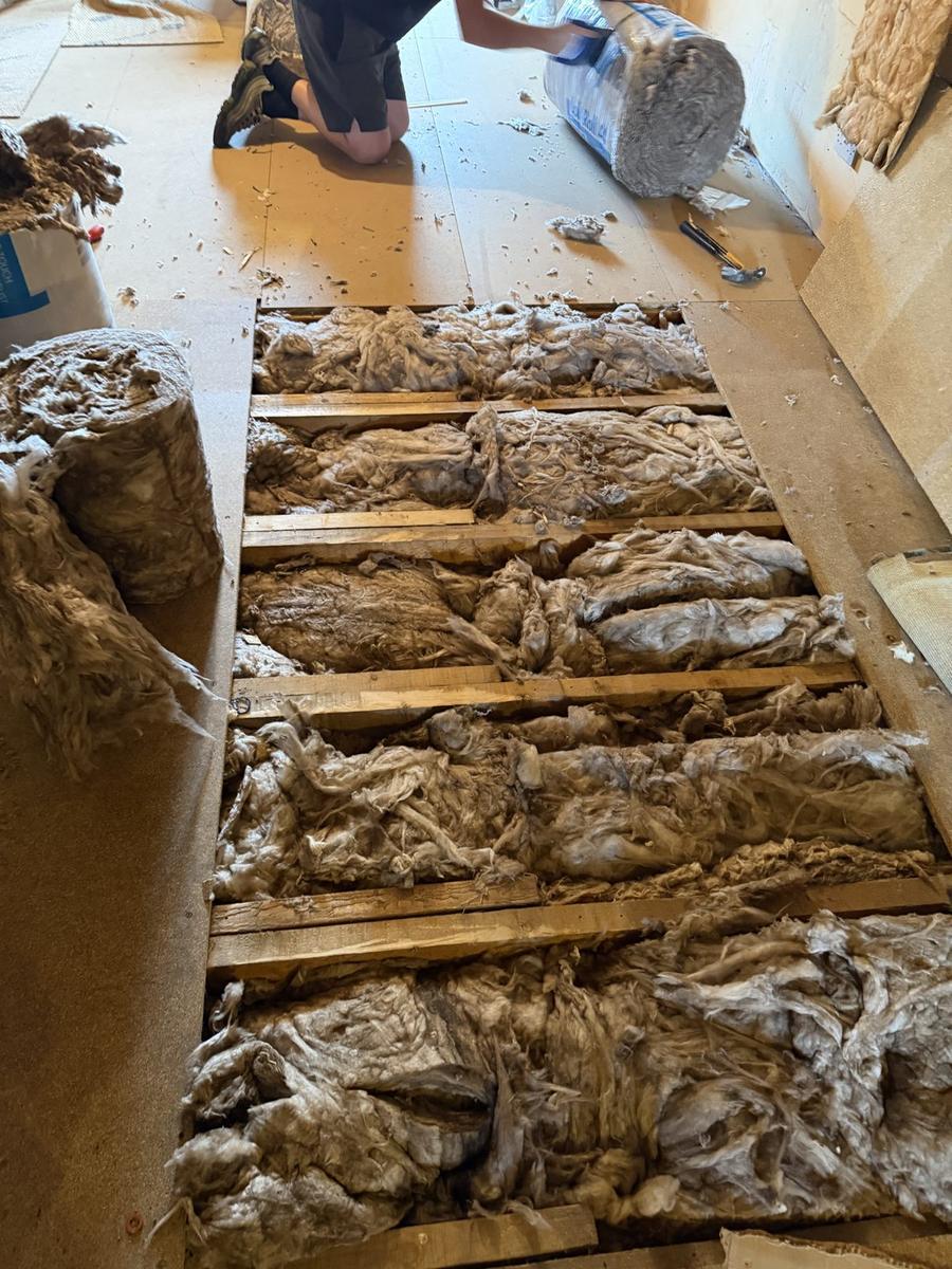 Knauf Earthwool insulation fitted between floor joists with the boards lifted, Nairn