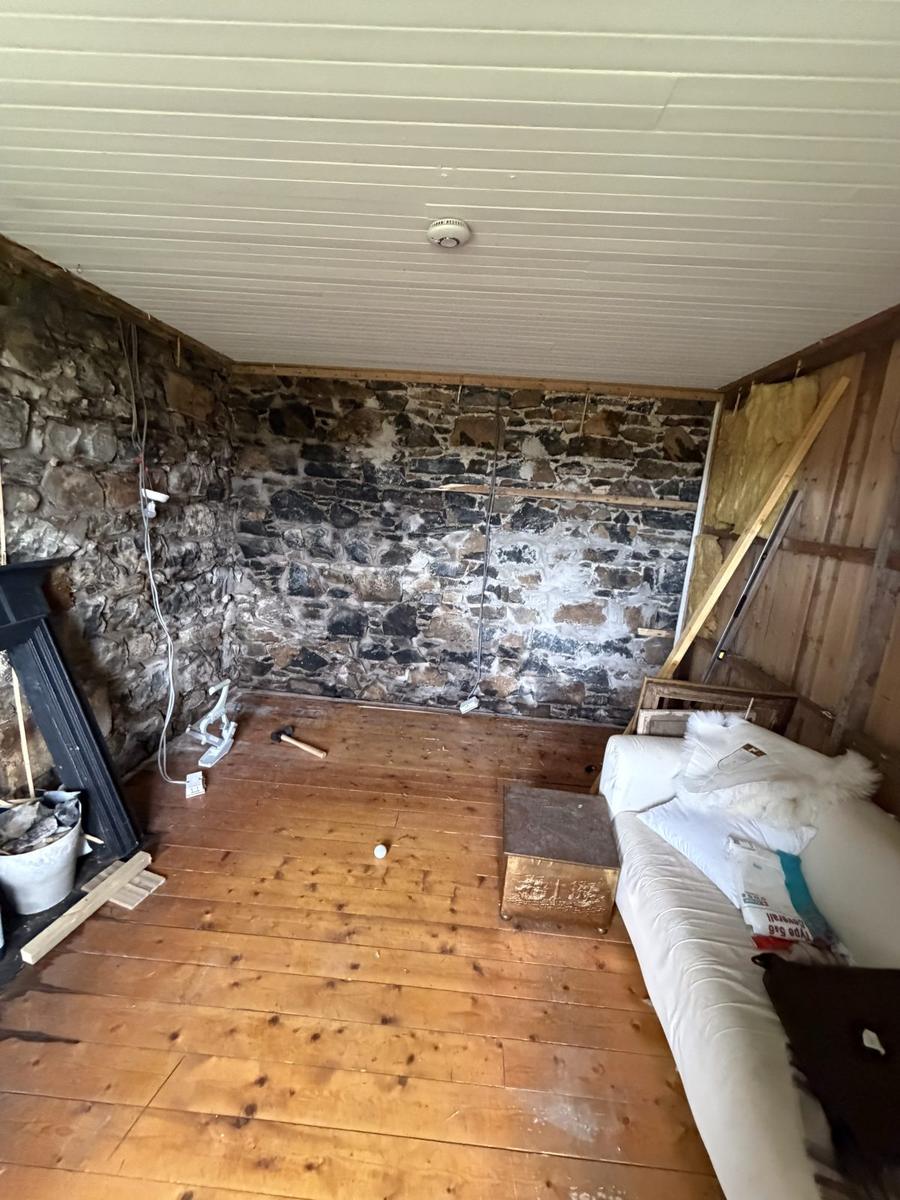 Corner of the stone room stripped back before insulation, Skye